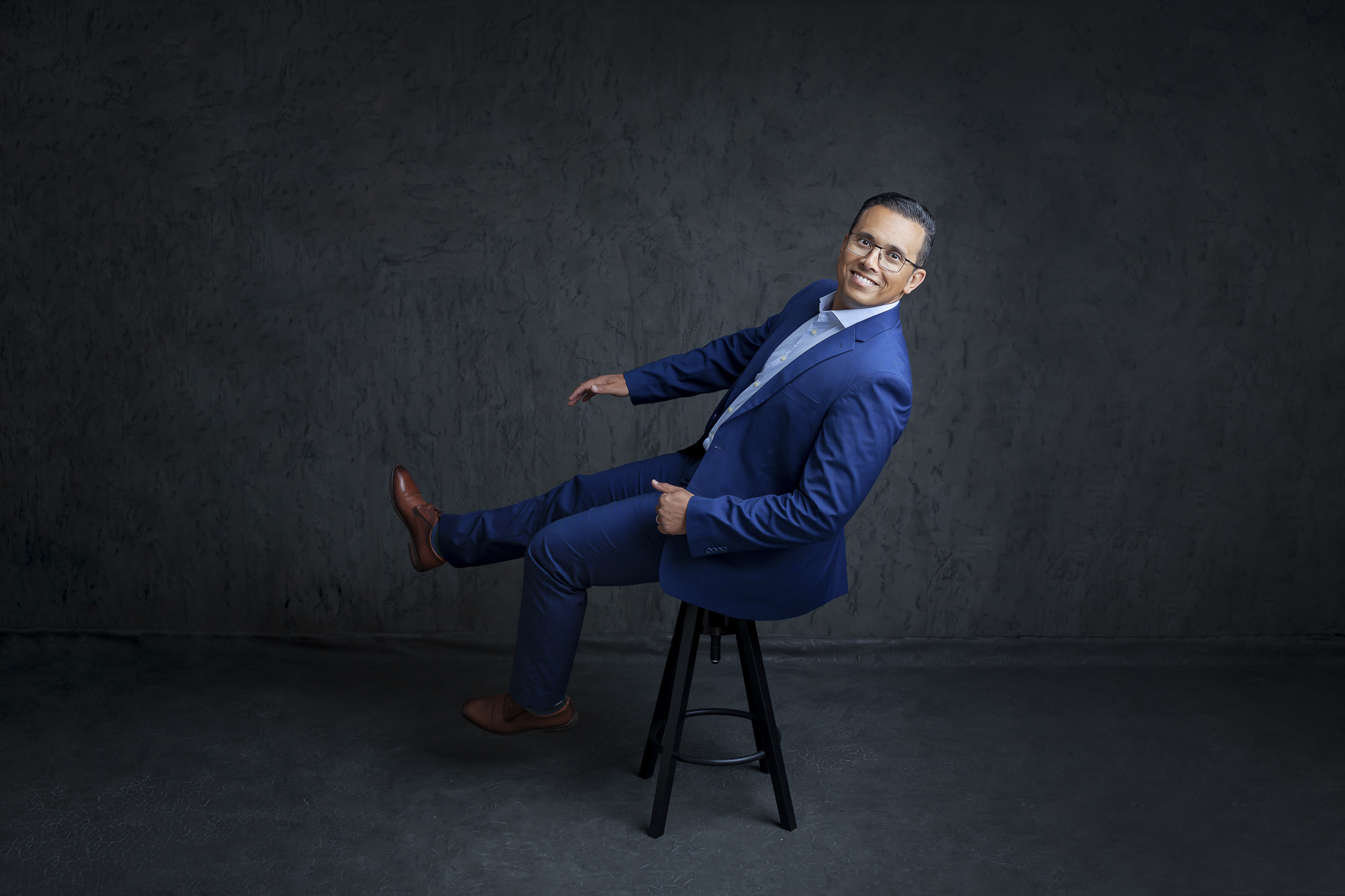 Professional photo spinning on a chair in photography studio.