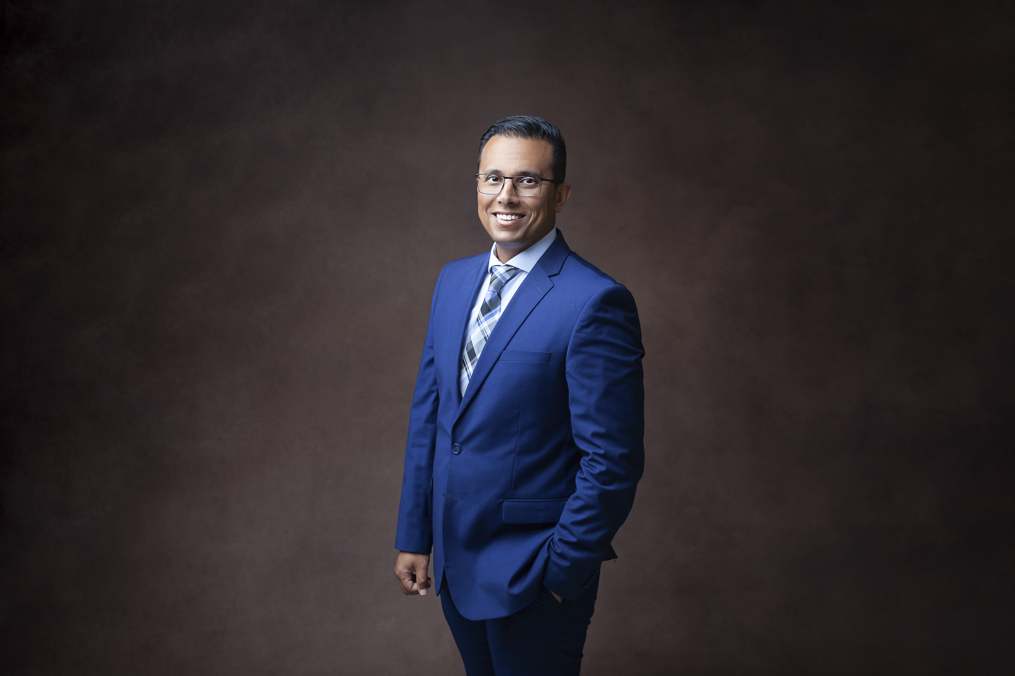 Business photo of a man smiling at camera.