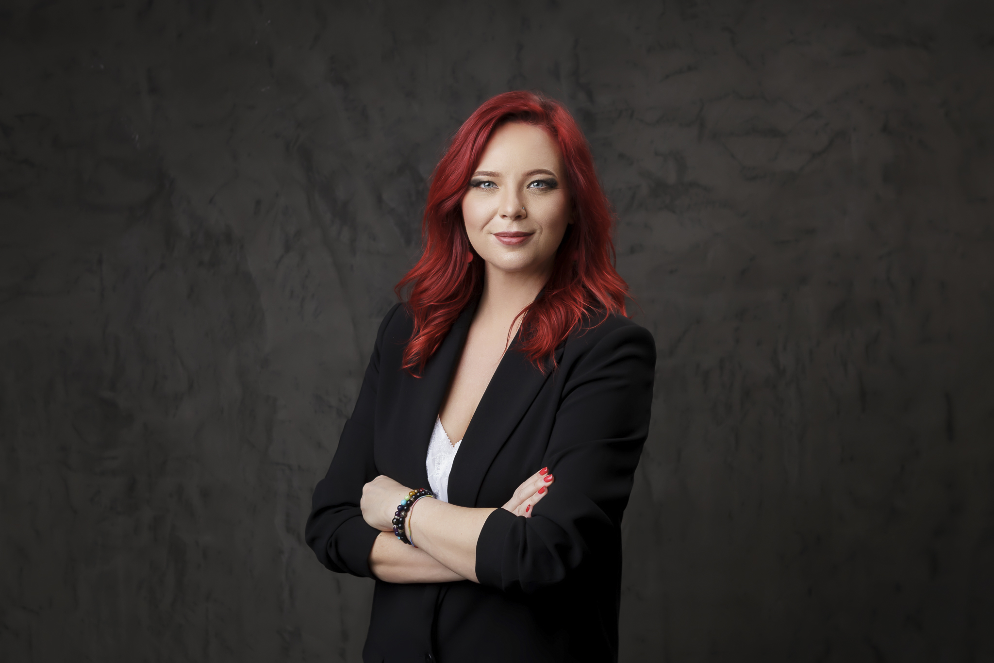 Businesswoman posing for her professional portrait in photography studio.