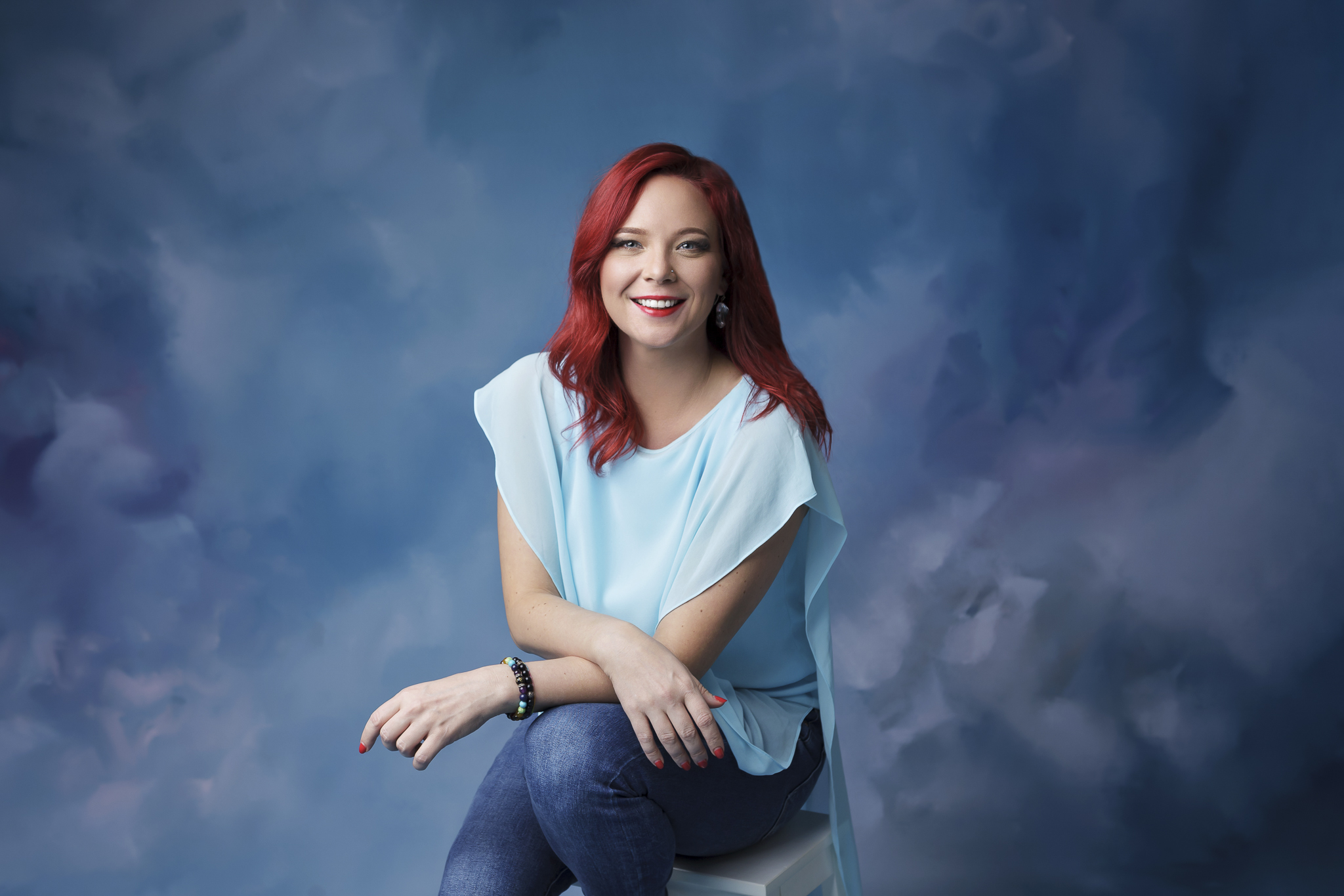 Business owner posing for her professional portrait in photography studio.