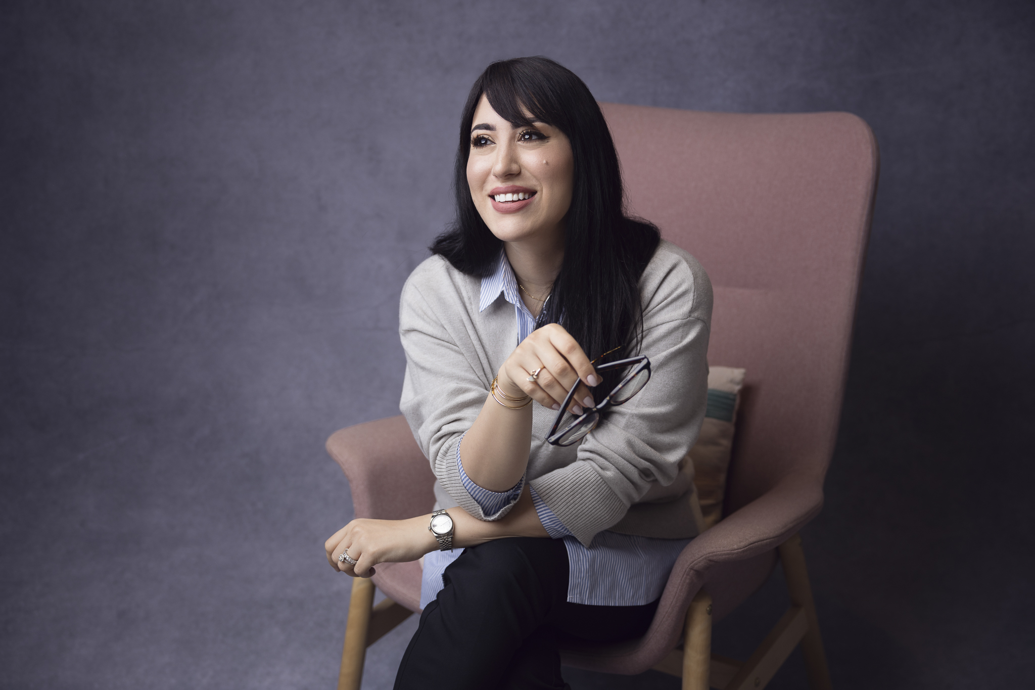 Professional photo of a writer sitting in an armchair.